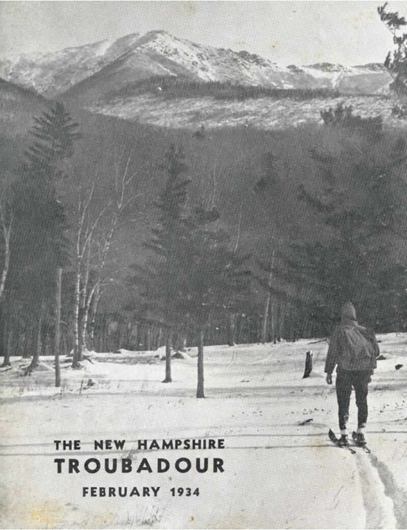 A person on snowshoes walking through a snowy landscape with bare birch trees in the foreground and a snow-capped mountain in the background.