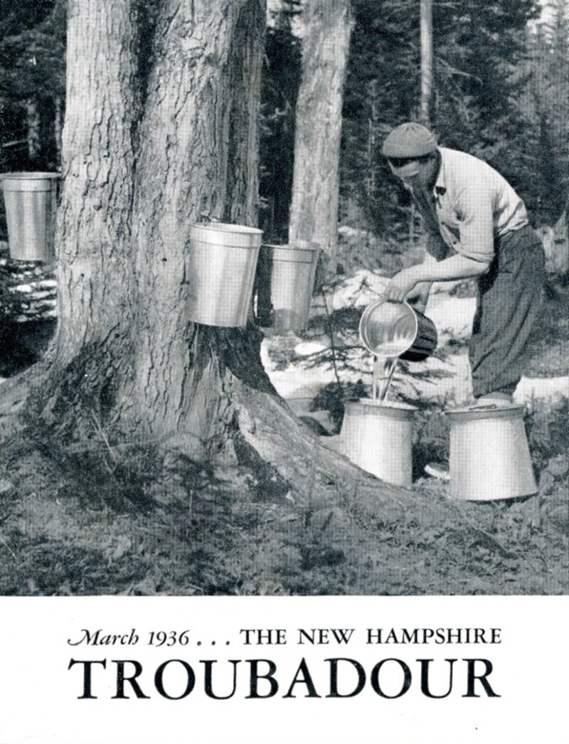 A man in a cap and work clothes collecting maple sap from buckets attached to large maple trees, pouring sap through a strainer into a larger container, with snow visible on the ground in a wooded setting.